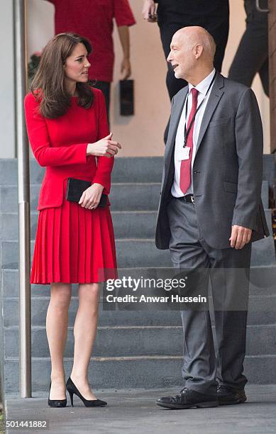 Catherine, Duchess of Cambridge, wearing a red Alexander McQueen dress, attends the Anna Freud Centre Family School Christmas Party at the Anna Freud...
