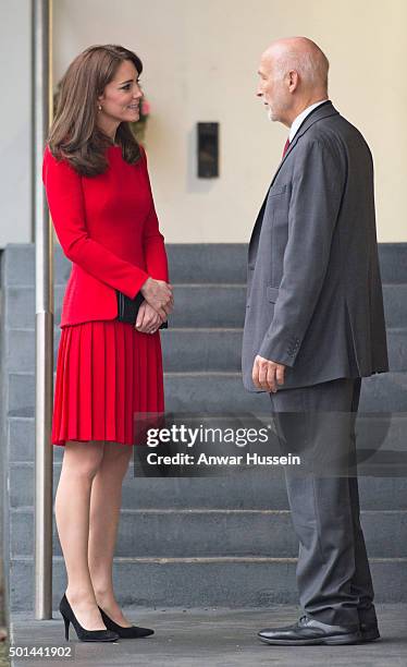 Catherine, Duchess of Cambridge, wearing a red Alexander McQueen dress, attends the Anna Freud Centre Family School Christmas Party at the Anna Freud...