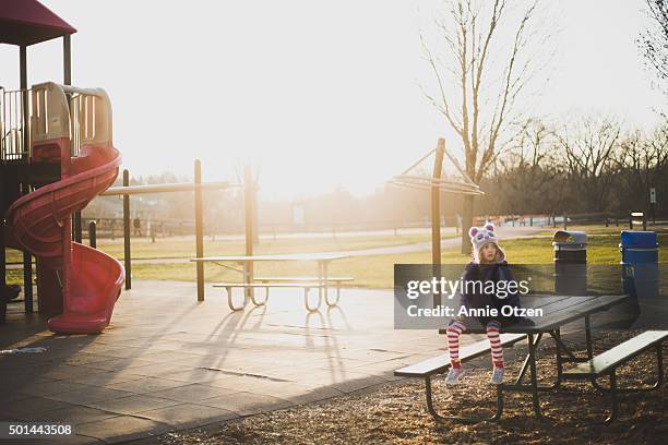 little girl on a picnic bench - climbing frame stock pictures, royalty-free photos & images