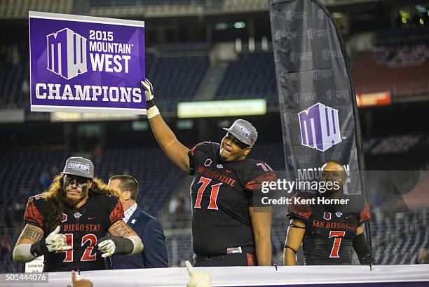 Pearce Slater of the San Diego State Aztecs holds a champions sign after winning the Mountain West Championship game against the Air Force Falcons at...