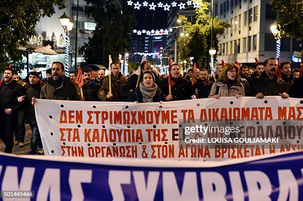 Communist-affiliated protesters march towards the Greek parliament in Athens on December 15, 2015 as MPs vote on a set of reforms demanded by...