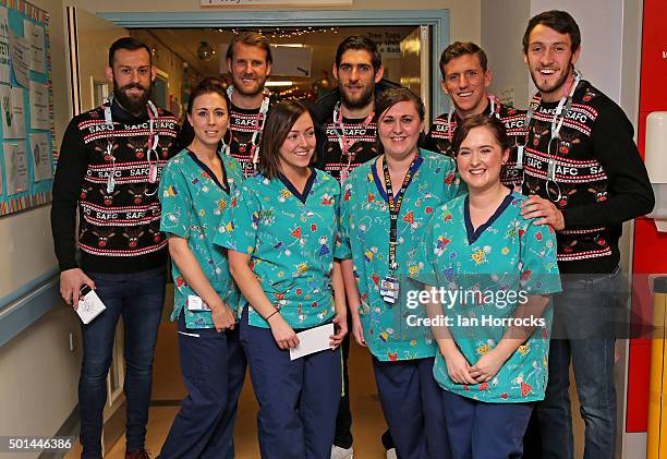 Sunderland players pose with staff the children wards at Durham University Hospital on December 15, 2015 in Sunderland, England.