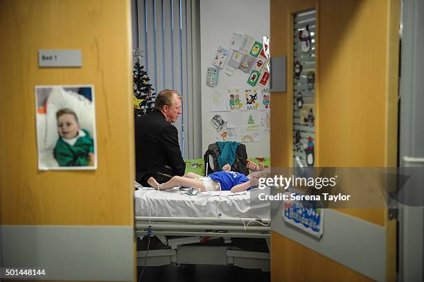 Newcastle Head Coach Steve McClaren sits on the bed of a poorly child during Newcastle United's Christmas Hospital Visit at the Royal Victoria...