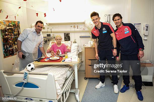 Newcastle Players Freddie Woodman and Daryl Janmaat pose for a photo after giving presents to a poorly child during Newcastle United's Christmas...