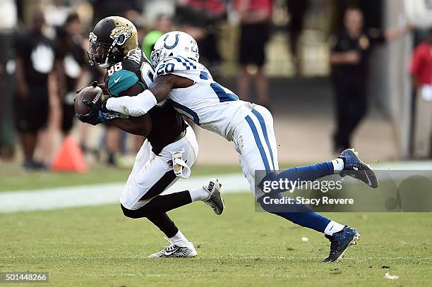 Allen Hurns of the Jacksonville Jaguars is brought down by Darius Butler of the Indianapolis Colts during a game at EverBank Field on December 13,...