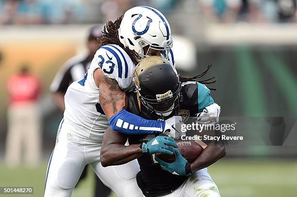 Denard Robinson of the Jacksonville Jaguars is brought down by Dwight Lowery of the Indianapolis Colts during a game at EverBank Field on December...