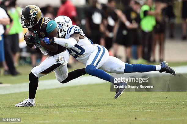 Allen Hurns of the Jacksonville Jaguars is brought down by Darius Butler of the Indianapolis Colts during a game at EverBank Field on December 13,...