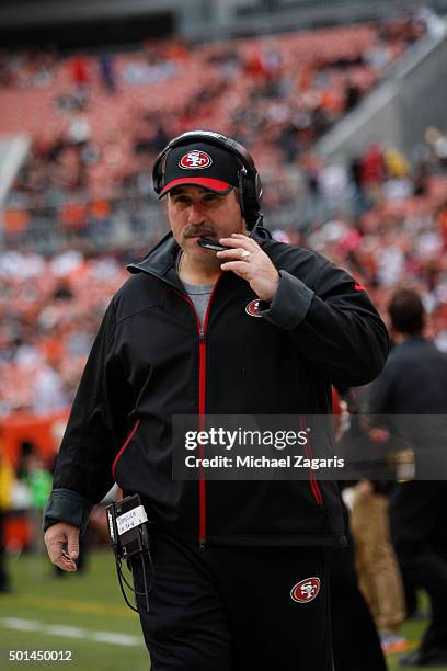 Head Coach Jim Tomsula of the San Francisco 49ers stands on the field prior to the game against the Cleveland Browns at Browns Stadium on December...