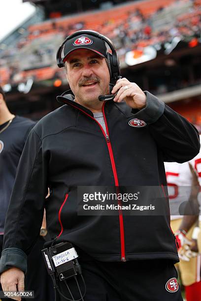 Head Coach Jim Tomsula of the San Francisco 49ers stands on the field prior to the game against the Cleveland Browns at Browns Stadium on December...