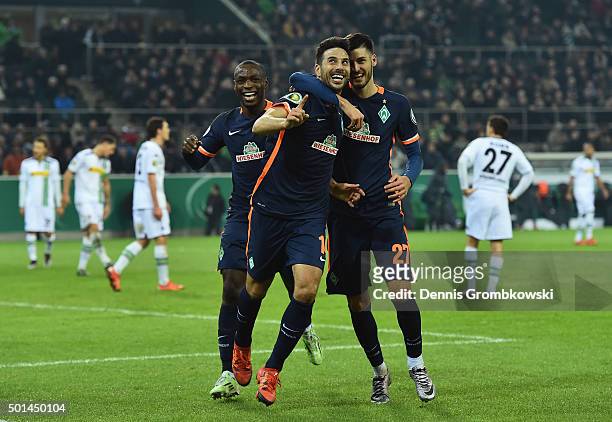 Claudio Pizarro of Werder Bremen celebrates with team mates as he scores the third goal during the DFB Cup Round of 16 match between Borussia...
