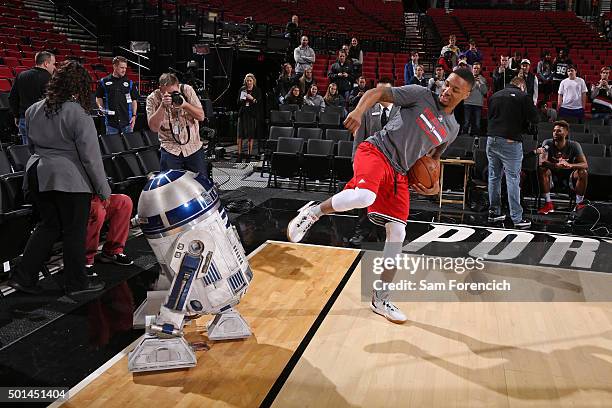 Damian Lillard of the Portland Trail Blazers poses for a photo with Star Wars characters before the game against the New Orleans Pelicans on December...