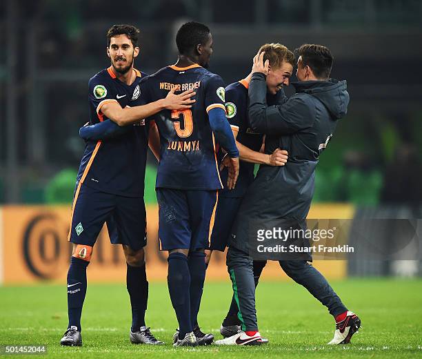 Janek Sternberg of Bremen celebrates with Assani Lukimya, Santiago García and Assani Lukimya at the end of the DFB Pokal match between Borussia...