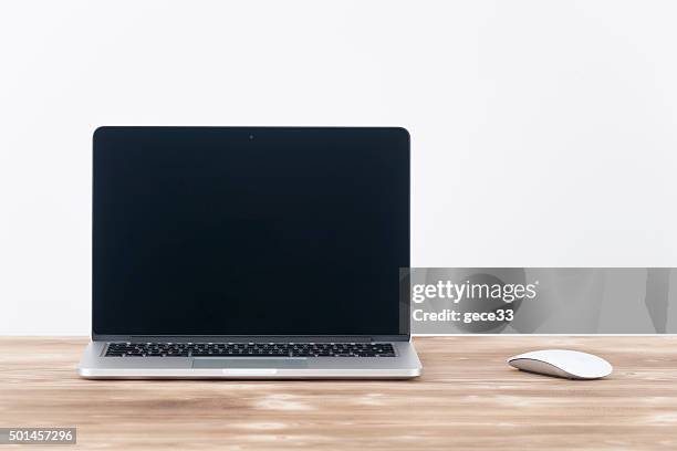 apple macbook pro.with apple magic mouse 2 on table. - mac book stock pictures, royalty-free photos & images