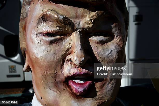 Paper mache likeness of republican presidential candidate Donald Trump sits on the sidewalk during a demonstration before the start of the CNN...