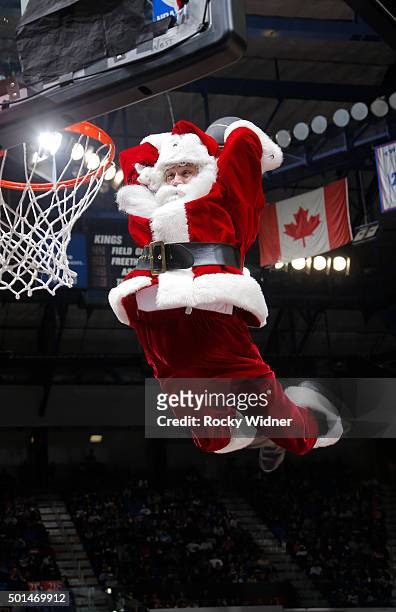 Man dressed as Santa Claus dunks during the game between the New York Knicks and Sacramento Kings on December 10, 2015 at Sleep Train Arena in...