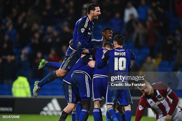 Cardiff players mob Scorer of the third goal Kenwyne Jones during the Sky Bet Championship match between Cardiff City and Brentford at Cardiff City...