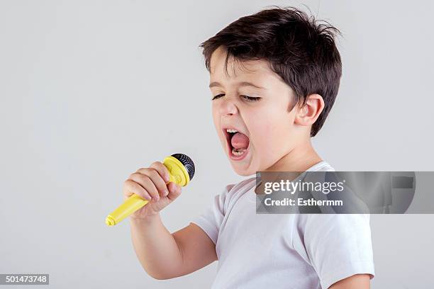 child singing - boy singing stock-fotos und bilder