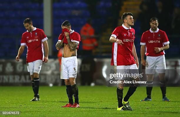 Scott Burton of Salford City and his team-mates look on dejectedly after conceding the first goal in extra time during the Emirates FA Cup second...