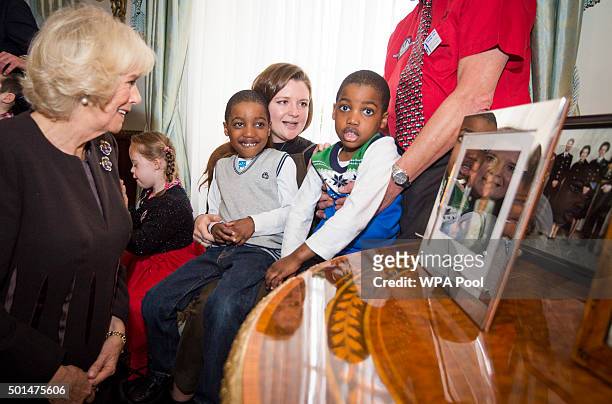 Twins Adam and Aten Ndaka 5 join Camilla, Duchess of Cornwall, patron of the Helen & Douglas House and The London Taxidrivers' Fund as she invites...