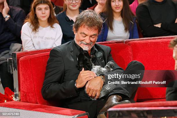 Main Guest of the Show actor Olivier Marchal and a little dog attend the 'Vivement Dimanche' French TV Show at Pavillon Gabriel on December 15, 2015...