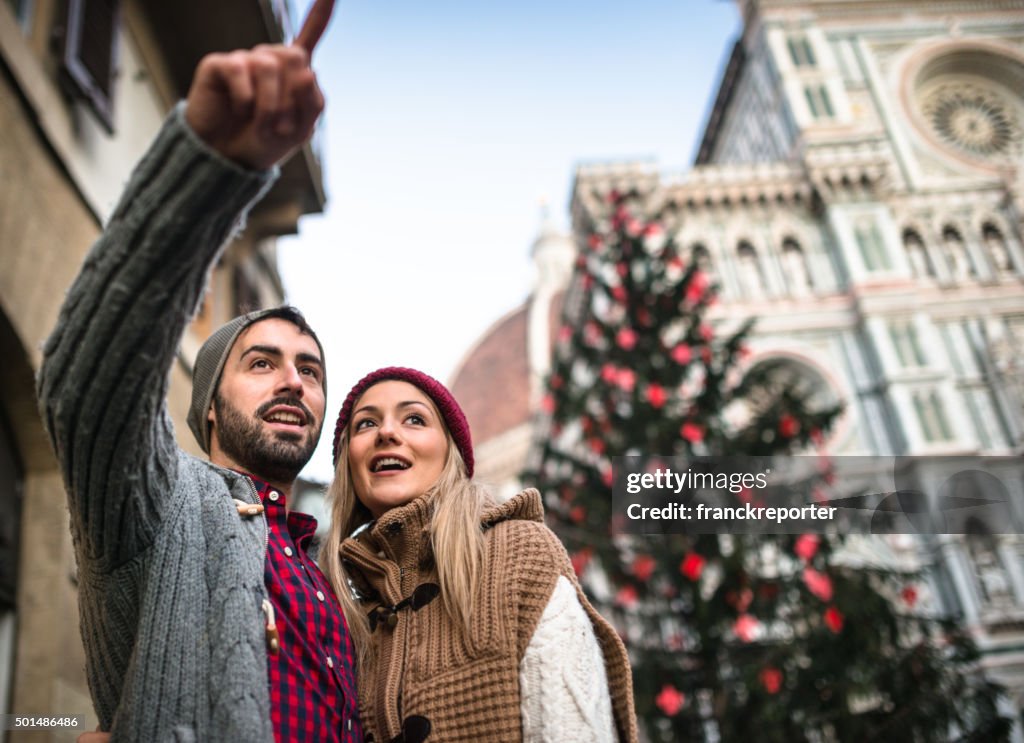 Couple in Florence for christmas with christmas tree