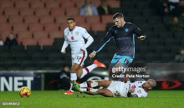 Gary Hooper of Sheffield Wednesday is tackled by Samir Carruthers of Milton Keynes Dons during the Sky Bet Championship match between Milton Keynes...