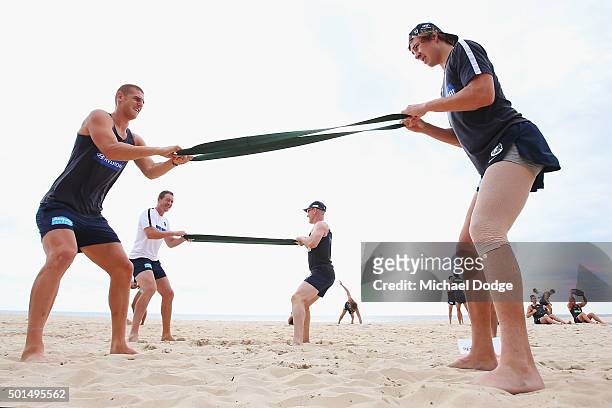 Liam Jones and Charlie Curnow stretch a band during a circuit training session at Kurrawa Beach during the Carlton Blues AFL pre-season training camp...