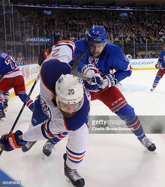 Dylan McIlrath of the New York Rangers checks Luke Gazdic of the Edmonton Oilers during the first period at Madison Square Garden on December 15,...