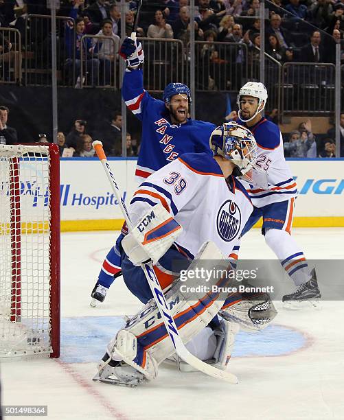 Dominic Moore of the New York Rangers celebrates a second period goal by Dylan McIlrath against Anders Nilsson of the Edmonton Oilers at Madison...