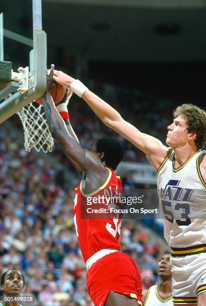 Hakeem Olajuwon of the Houston Rockets has his shot blocked by Mark Eaton of the Utah Jazz during an NBA basketball game circa 1990 at the Salt...