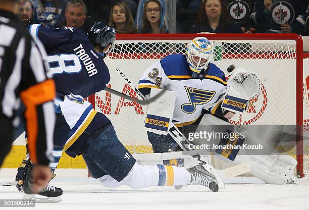 Jacob Trouba of the Winnipeg Jets gets a shot on goaltender Jake Allen of the St. Louis Blues during first period action at the MTS Centre on...