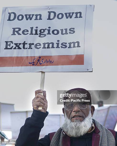 Pakistani activists carries placard during a rally to pay tribute to the victims of the Peshawar school massacre of December 16 the deadliest terror...