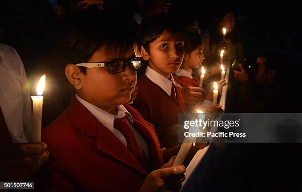 Pakistani students lit candles during a vigil to pay tribute to the victims of the Peshawar school massacre of December 16 the deadliest terror...