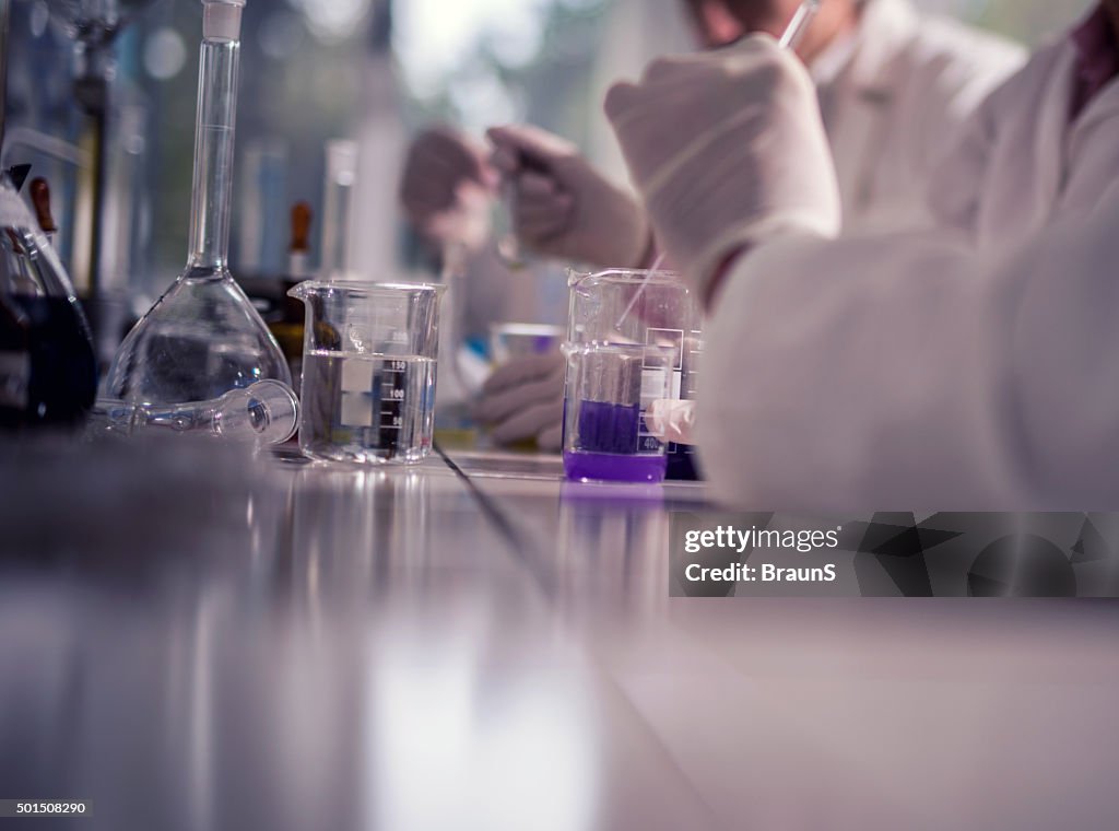 Unrecognizable doctor working with chemicals in a laboratory.