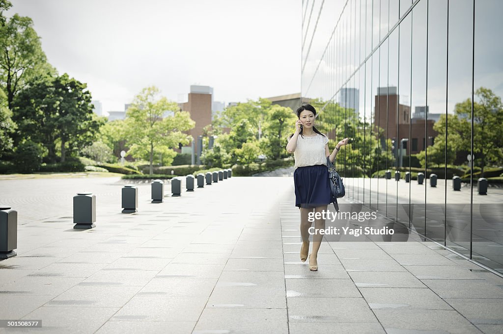 Woman walking in front of office building
