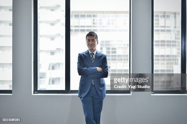 portrait of confident businessman in office - portrait business japanese stock pictures, royalty-free photos & images
