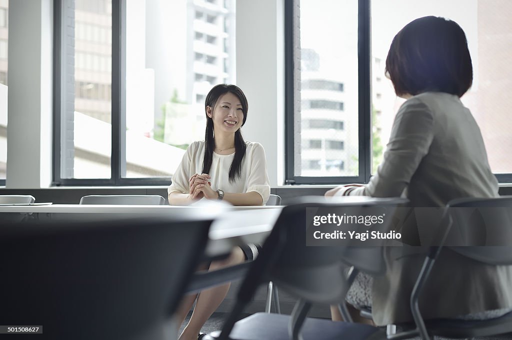 Two busuinessmen having a casual talk in meeting r
