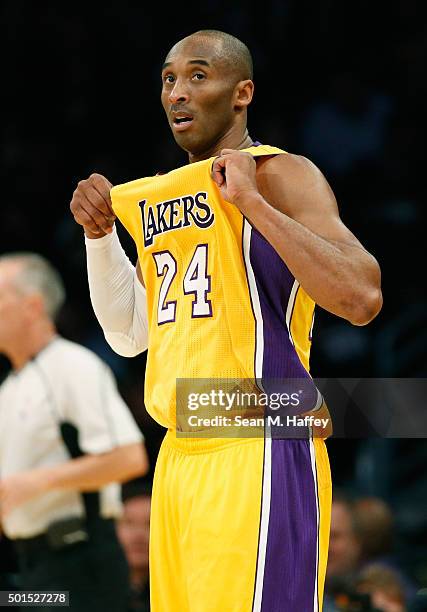 Kobe Bryant of the Los Angeles Lakers holds his jersey during the first half of a game against the Milwaukee Bucks at Staples Center on December 15,...