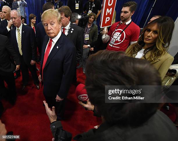 Republican presidential candidate Donald Trump and his wife Melania Trump talk to reporters in the spin room following the CNN presidential debate at...