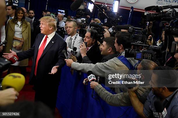 Republican presidential candidate Donald Trump and his wife Melania Trump talk to reporters in the spin room following the CNN presidential debate at...