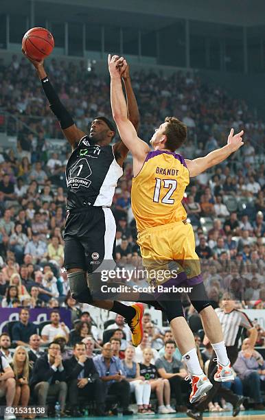 Hakim Warrick of Melbourne United drives to the basket as Angus Brandt of the Sydney Kings defends during the round 11 NBL match between Melbourne...