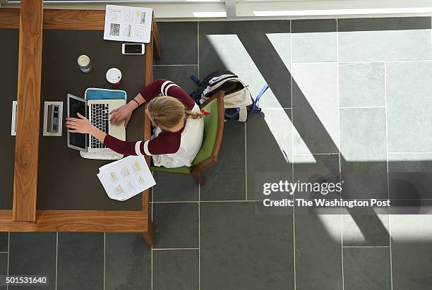 Person uses a desk to work within the Jerry Falwell Library on the campus of Liberty University on Thursday December 10, 2015 in Lynchburg, VA.