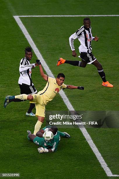 Sylvain Gbohouo of TP Mazembe saves at the feet of Osvaldo Martinez of Club America during the FIFA Club World Cup 5th Place Match between Club...
