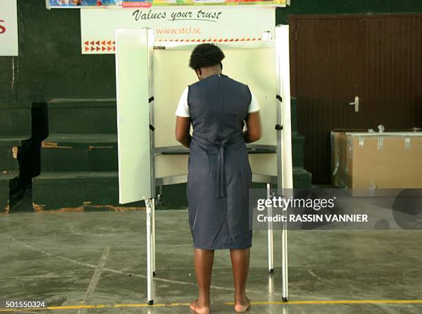 Woman casts her ballot for the presidential elections, on December 16, 2015 in Victoria, the capital of the Indian Ocean archipelago of the...