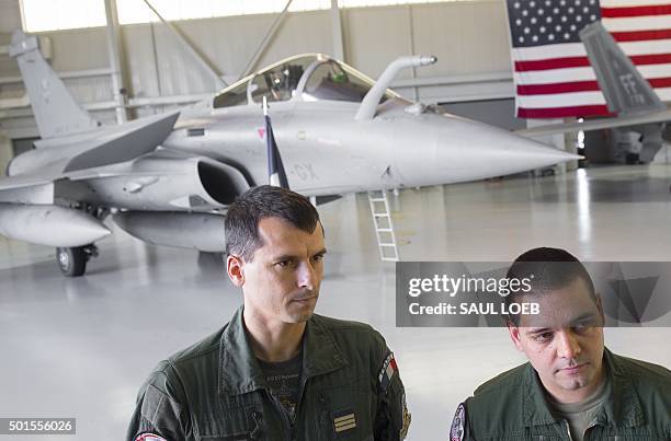 French Air Force pilots stand in front a Dassault Rafale fighter aircraft during the inaugural Trilateral Exercise between the US Air Force, United...