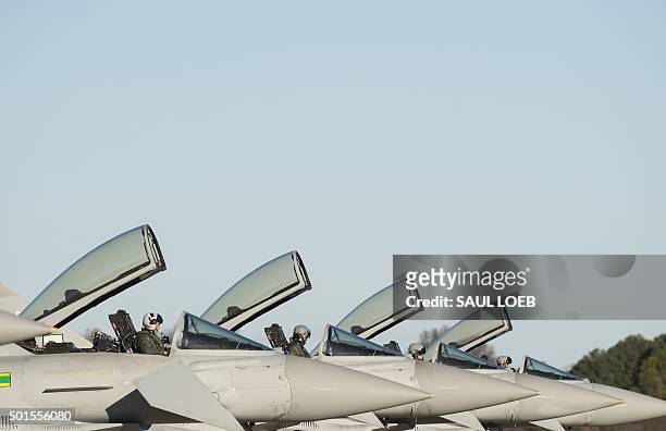 Royal Air Force pilots prepares their Eurofighter Typhoon aircraft for a flight during the inaugural Trilateral Exercise between the US Air Force,...