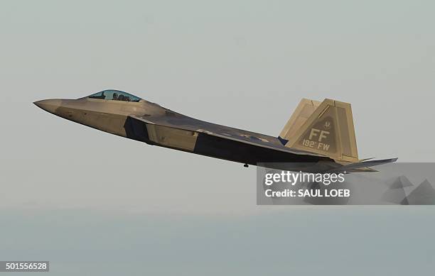 Air Force Lockheed Martin F-22 Raptor stealth fighter aircraft performs a demonstration flight during the inaugural Trilateral Exercise between the...