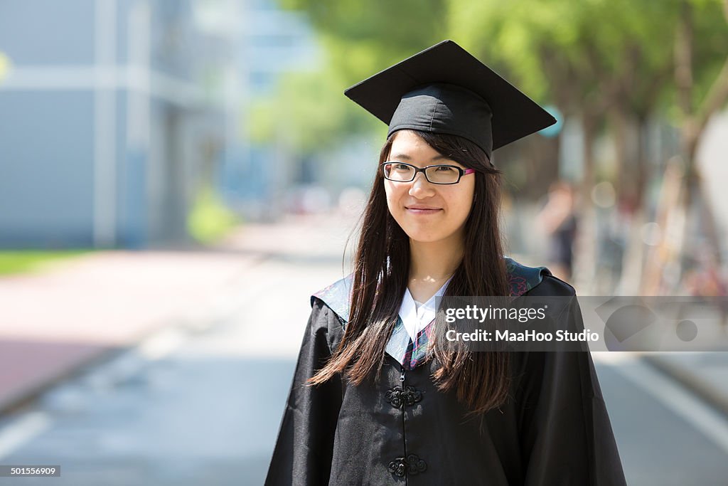 Young graduate wearing cap and gown