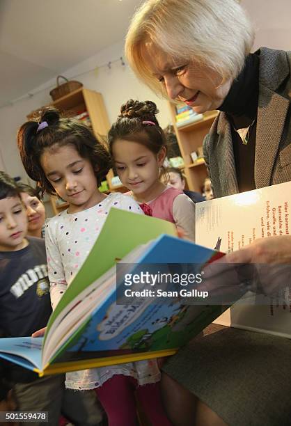 German Education Minister Johanna Wanka shares a book about fairy tales with immigrant children during the presentation of a new initiative to help...