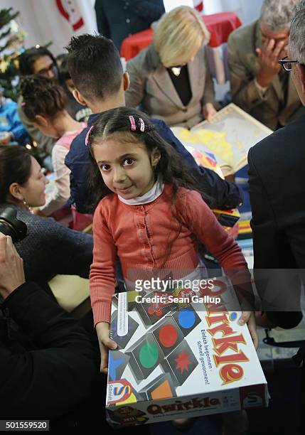 Dzhana a refugee child from Syria, clutches a game she received during the presentation of a new initiative to help children of refugees learn to...